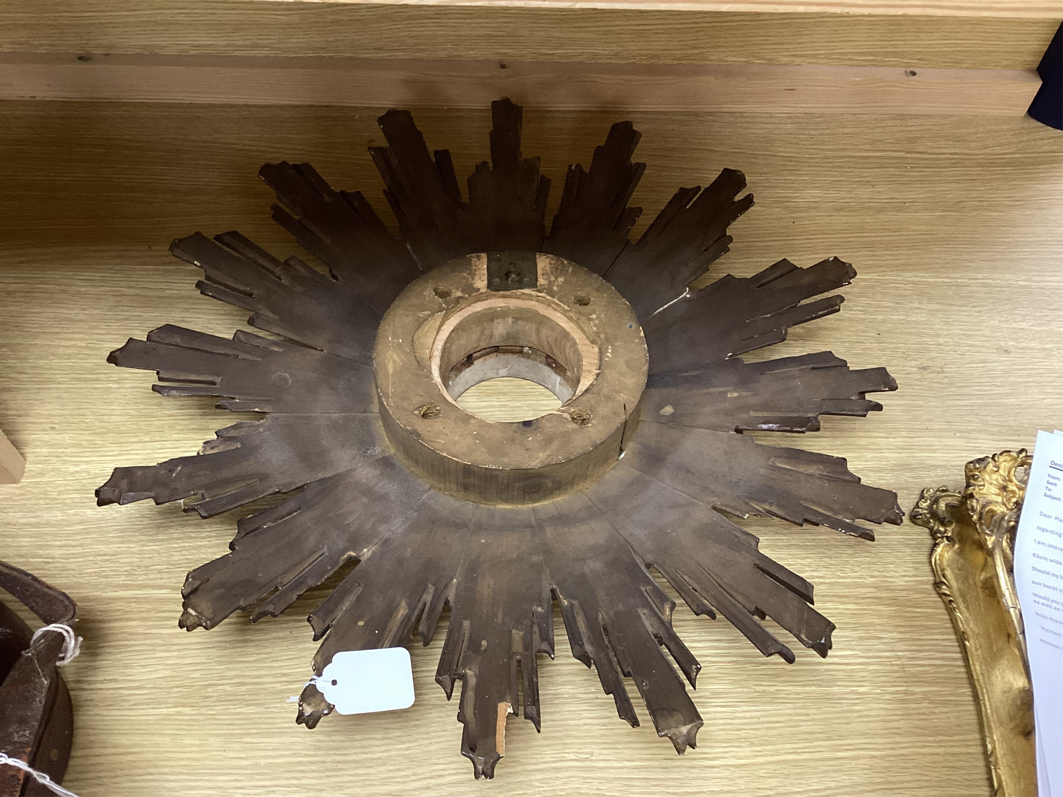 A gilt decorated sun burst clock frame, 63cm wide and a mid 19th century ornate gilt miniature frame
